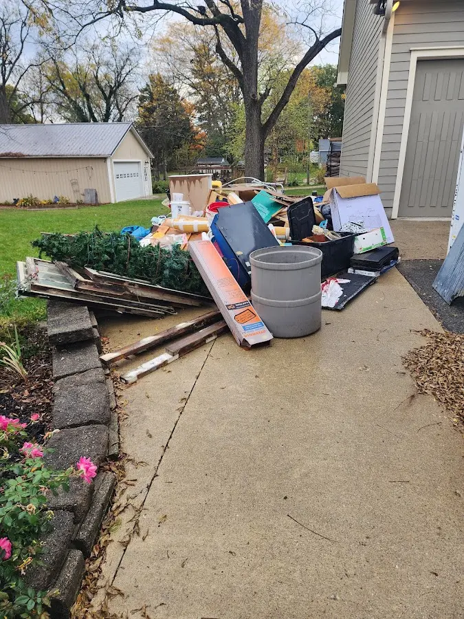 Dumpster being loaded with debris for Estate Cleanout Dumpster Rental in Scandia